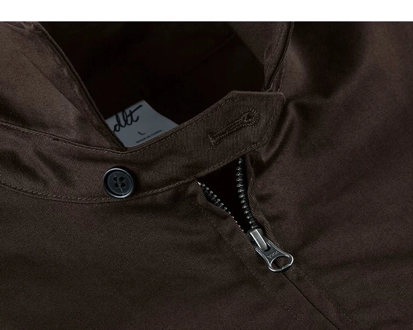 Close-up of the Harrington jacket inner collar, zipper placket, fastening button, size tag, and neat internal tailoring seams