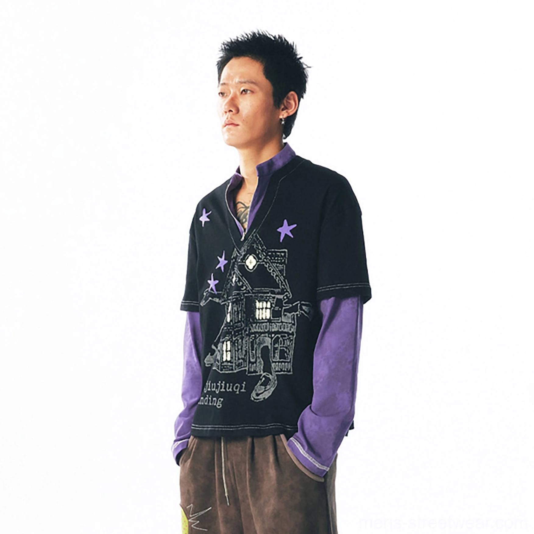 Three-quarter front view of a black purple haunted house graphic long sleeve streetwear tee with star details