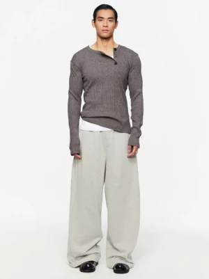 Heather gray asymmetric Henley rib knit sweater worn by male model in full body front view