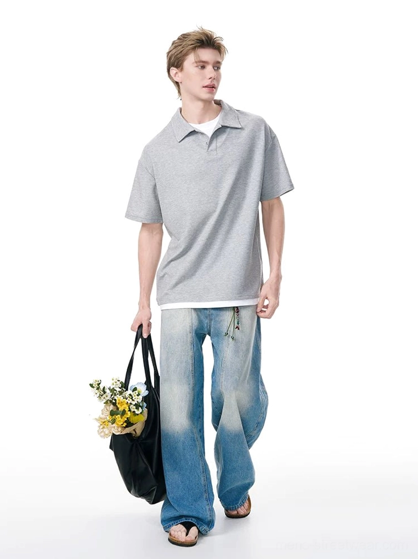 Heather gray boxy knit polo shirt with layered white undershirt, wide-leg jeans, and flower tote bag