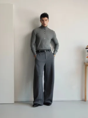 Heather gray long-sleeve knit polo shirt with woven contrast collar and half-button placket styled with dark gray wide-leg trousers