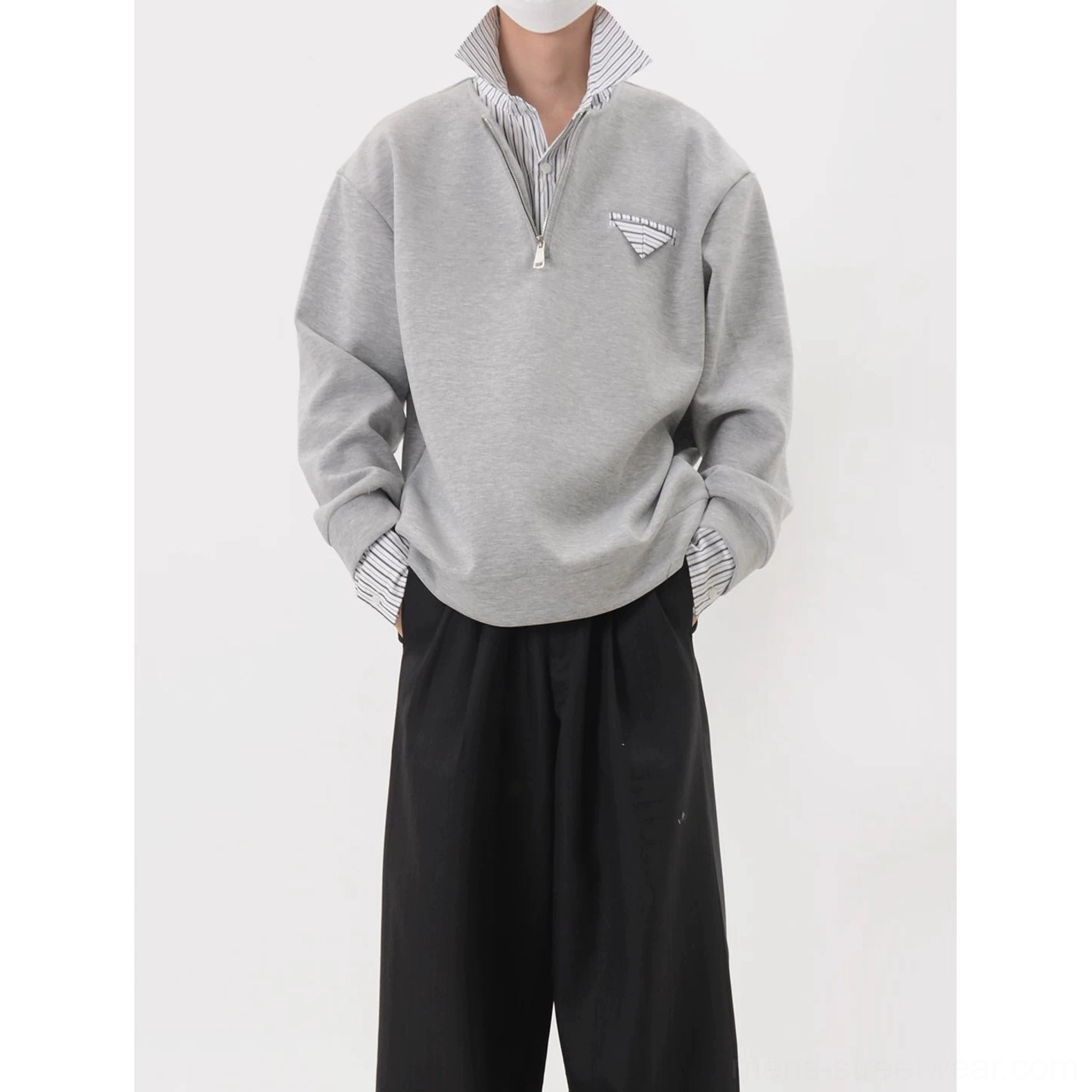 Front detail of a heather gray half-zip layered collar sweatshirt with striped collar and cuffs and relaxed sleeves