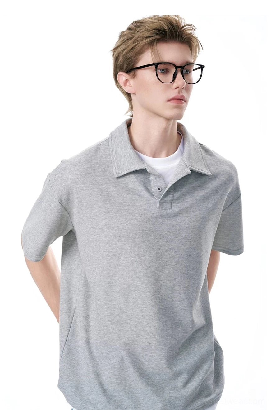 Back view of a heather gray relaxed knit polo shirt with drop shoulders and clean minimalist design