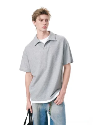 Heather gray relaxed knit polo shirt layered over a white T-shirt with blue jeans for Korean casual streetwear