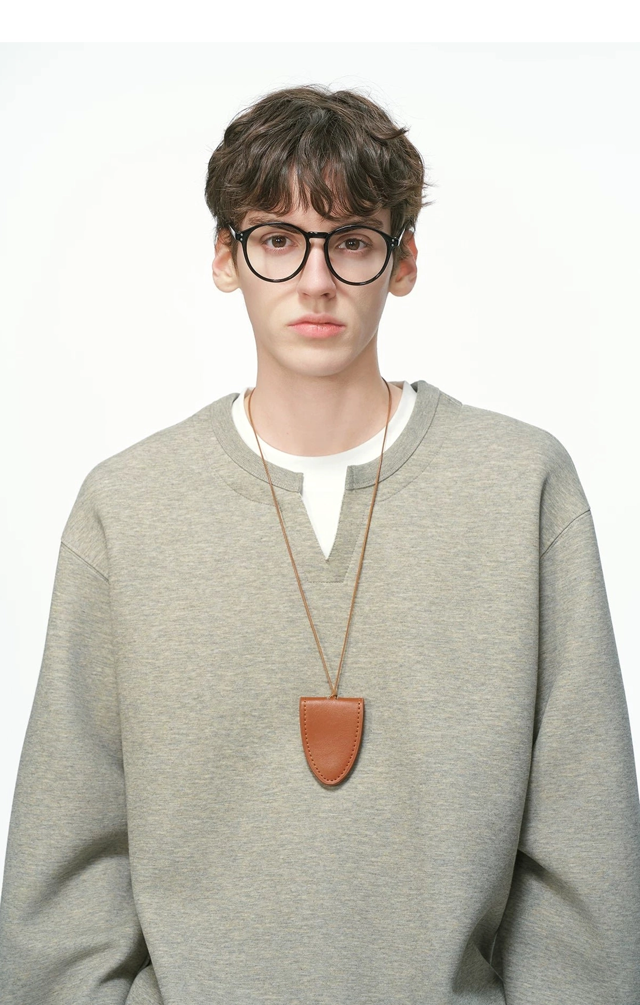 Close-up front view of a heather gray men's layered crew neck sweatshirt with contrasting white inner trim and smooth solid fabric
