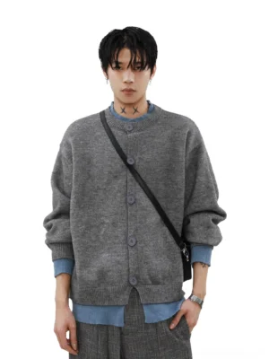 Men's heather gray oversized knit cardigan front view layered with blue shirt and black crossbody bag