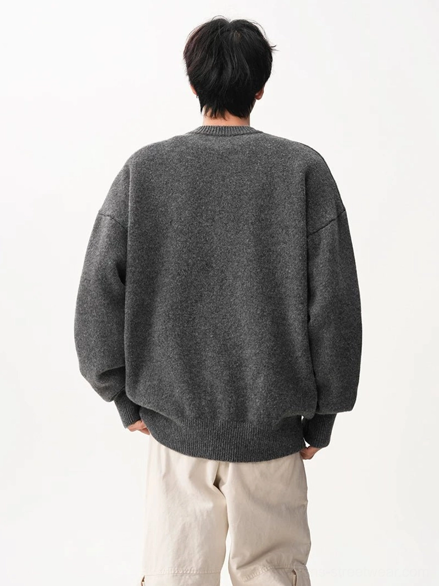 Back view of a heather gray oversized crew neck knit sweater with relaxed proportions, soft texture, and a clean ribbed hem