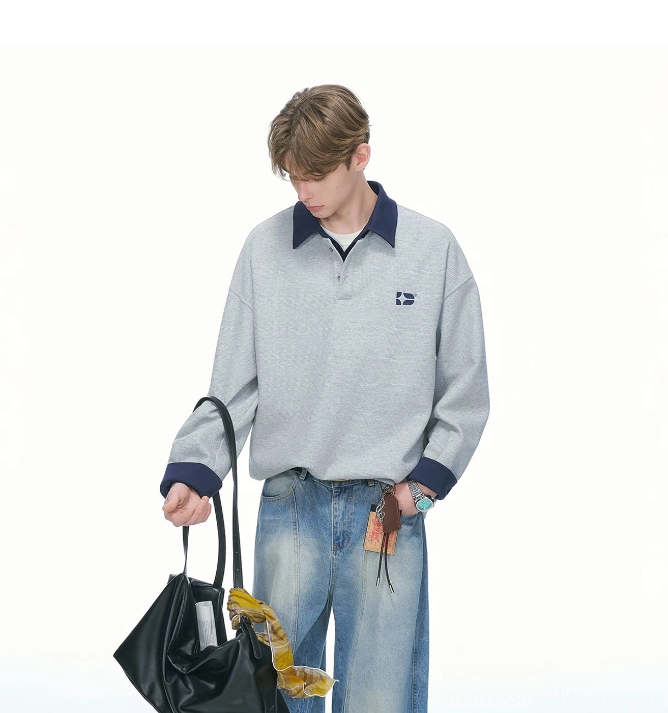 Heather gray rugby sweatshirt with dark blue contrast trims relaxed shoulders quarter-button placket and minimal chest embroidery