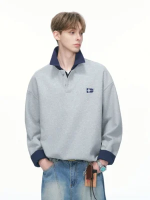 Heather gray varsity collar rugby sweatshirt with dark contrast collar cuffs relaxed fit and subtle embroidered chest detail