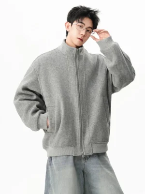 Heather gray wool stand collar zip bomber jacket in a front three-quarter view styled with light wash wide-leg jeans
