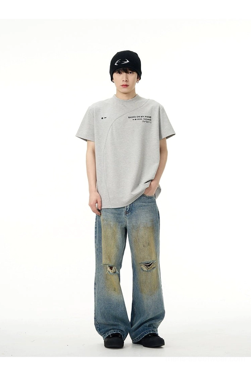 Heather grey Acid Techno streetwear T-shirt styled with distressed baggy jeans, chest slogan print, and diagonal seams