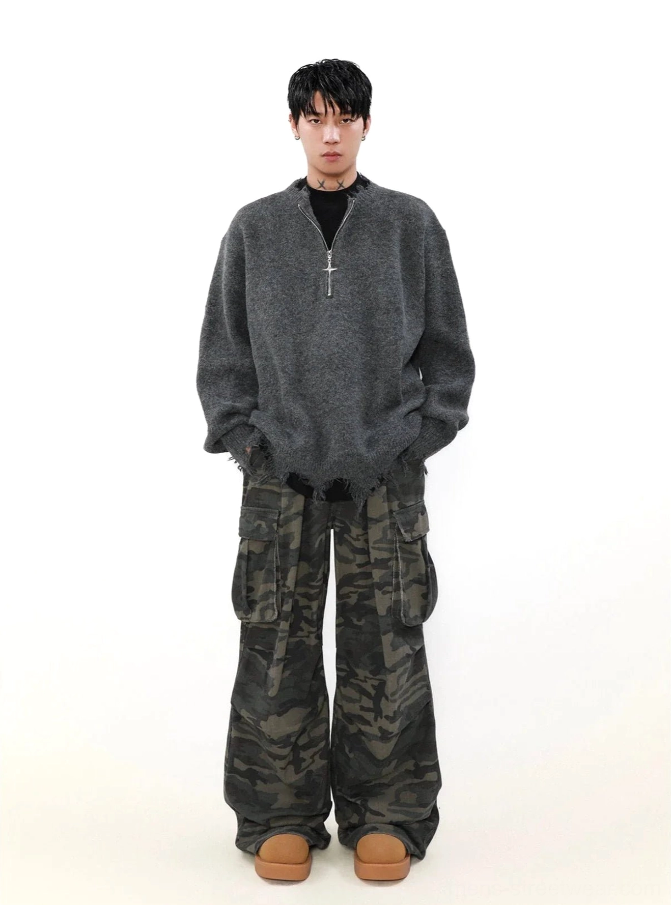 Heather grey cross-zipper half-zip streetwear sweater styled with camouflage cargo pants and loafers