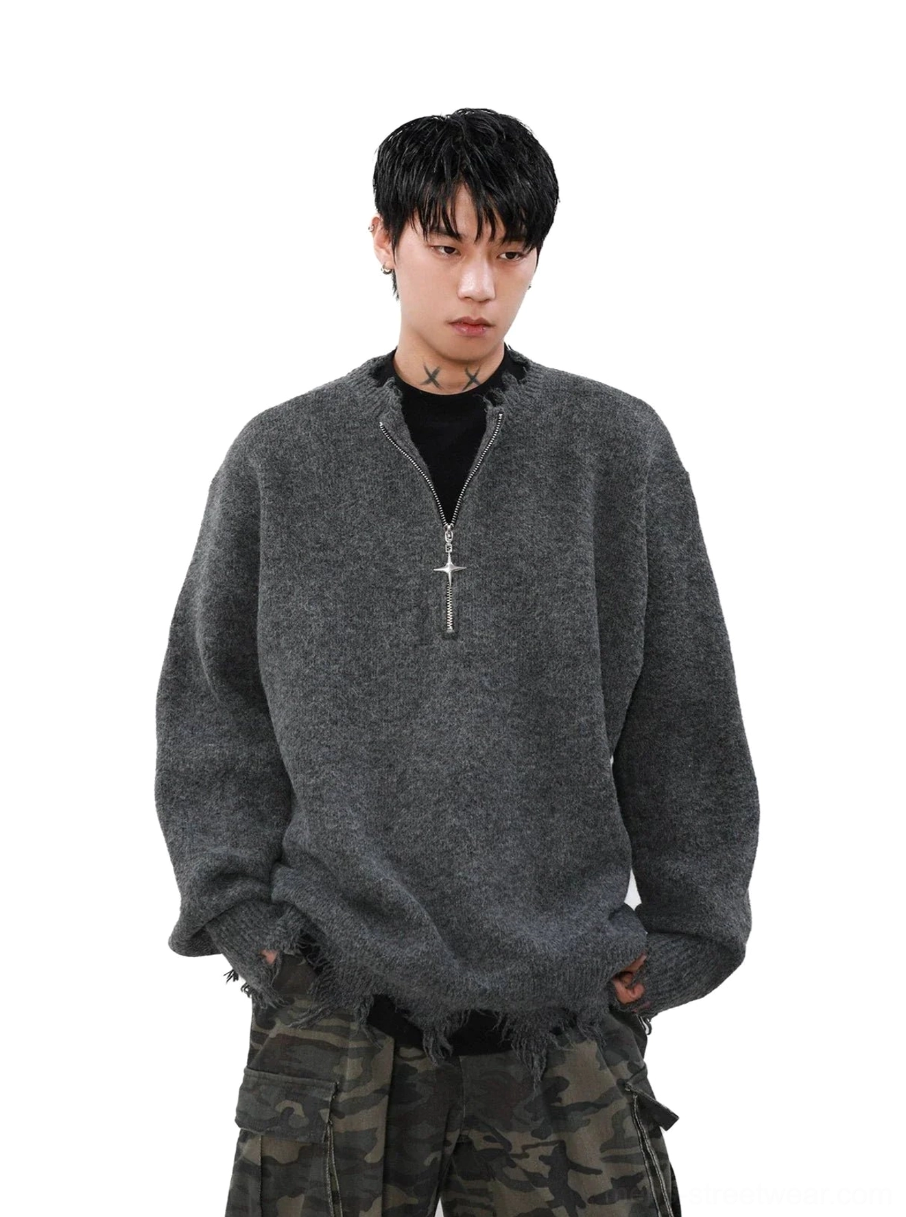 Heather grey distressed cross-zipper half-zip oversized streetwear sweater styled with camouflage cargo pants