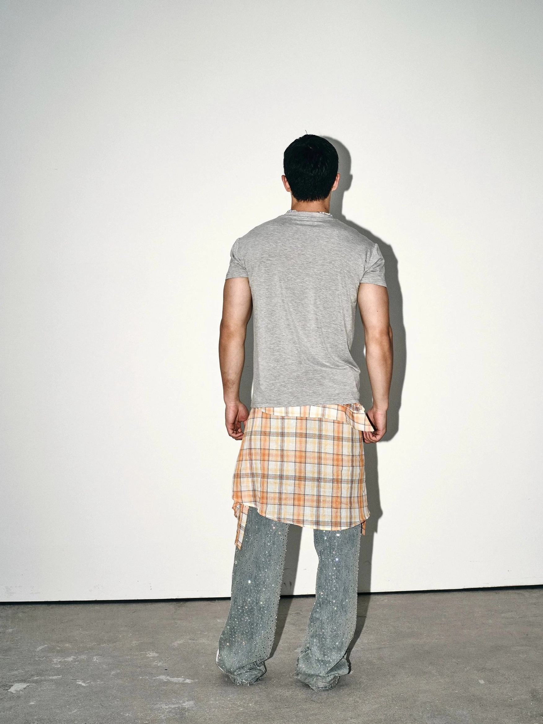 Back view of heather grey slim fit crew neck streetwear T-shirt showing clean minimal plain back design