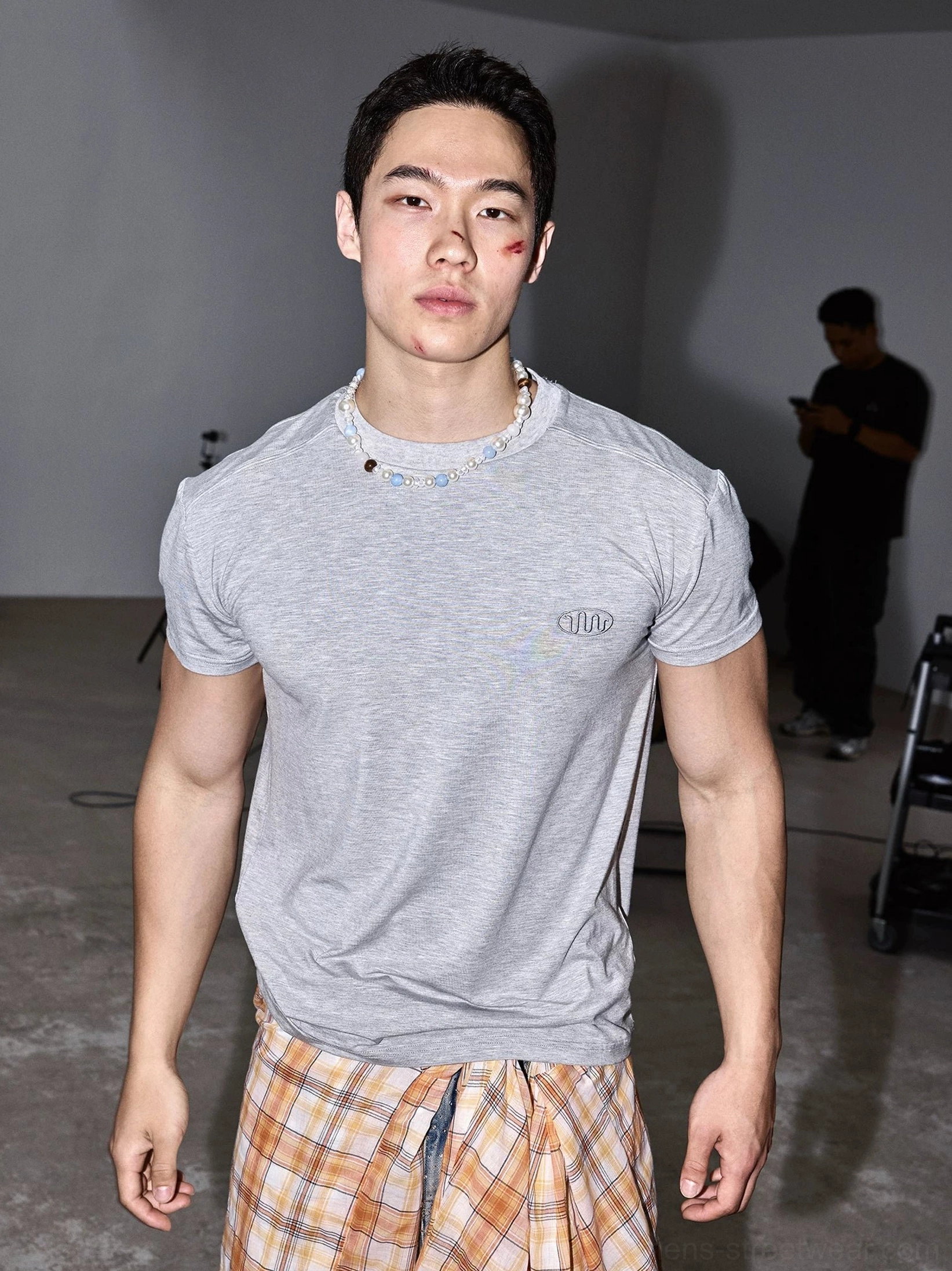 Heather grey fitted streetwear T-shirt with subtle embroidered chest logo shown in studio front view