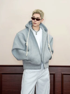 Heather grey oversized textured zip-up hoodie with thick drawstrings worn with white wide-leg pants in a Korean streetwear outfit