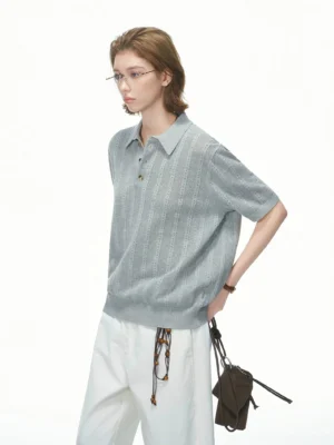 Heather grey relaxed pointelle knit polo shirt with vertical hollow knit stripes styled with white wide-leg pants