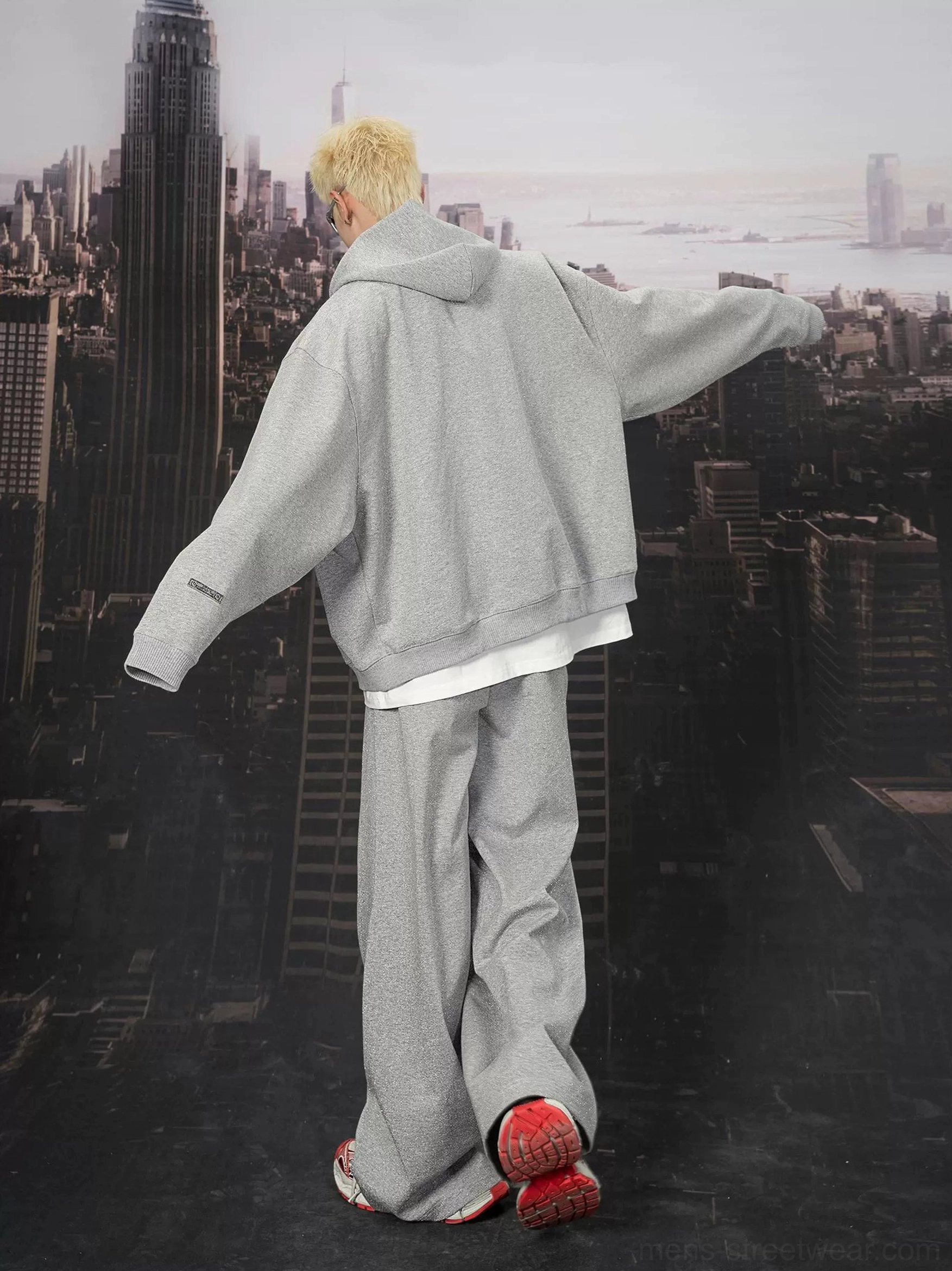 Back view of heather grey ultra wide sweatpants showing the relaxed oversized silhouette in an urban streetwear look