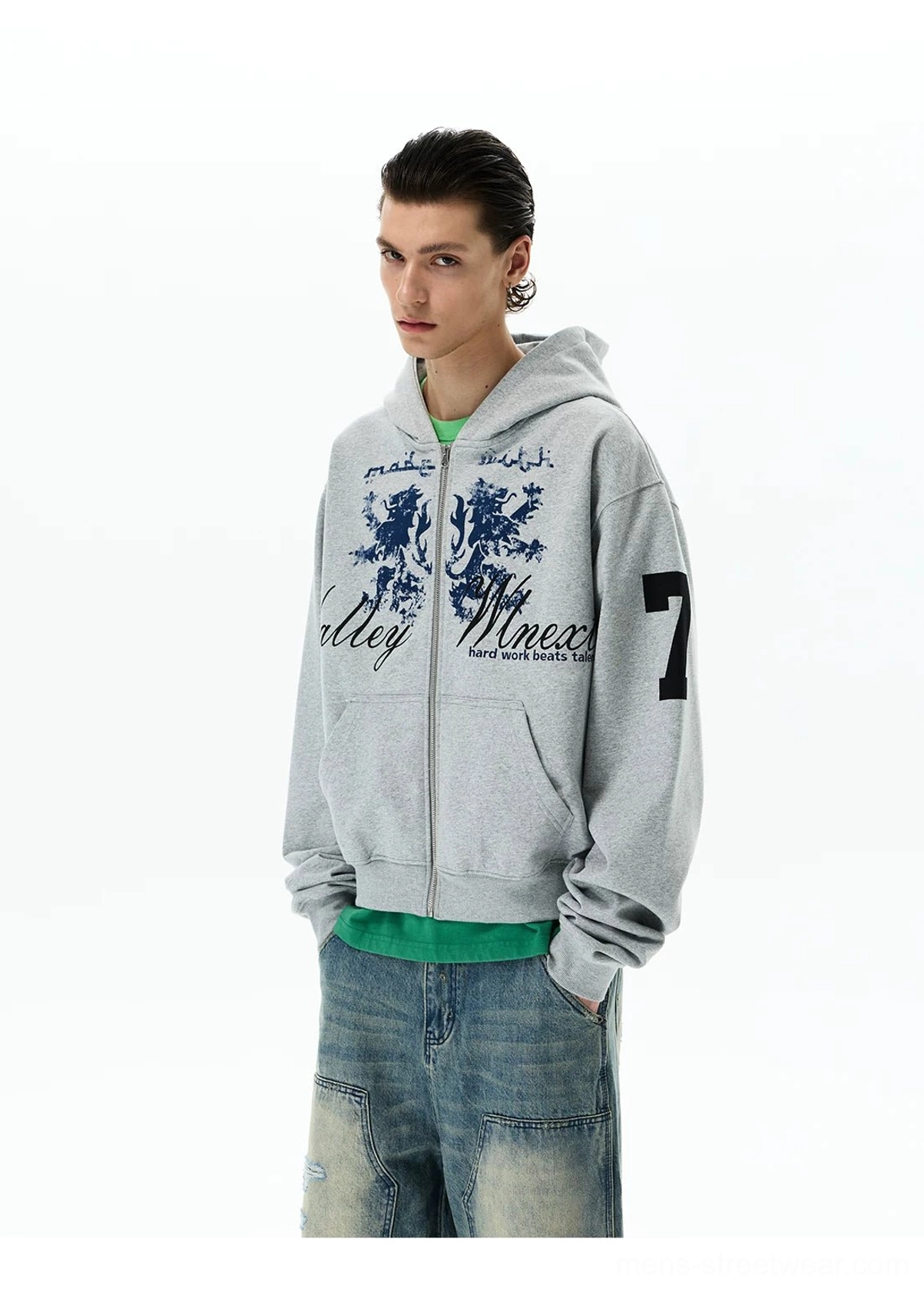 Front right three-quarter view of a heather grey vintage graphic zip hoodie with distressed crest, navy lettering, kangaroo pockets, and sleeve number 7