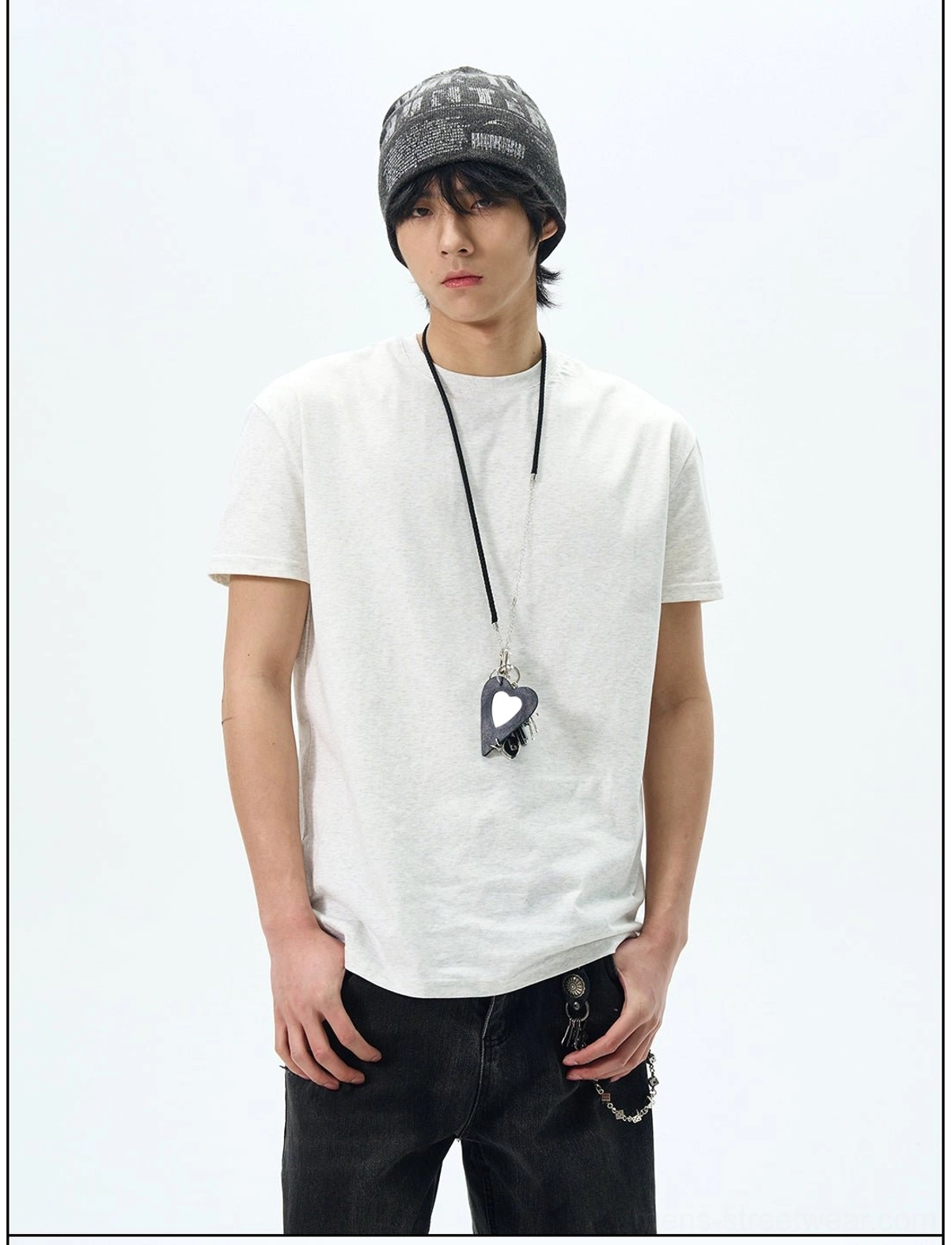 Heather white minimalist crew neck t-shirt styled with a beanie, long pendant necklace, and casual streetwear denim