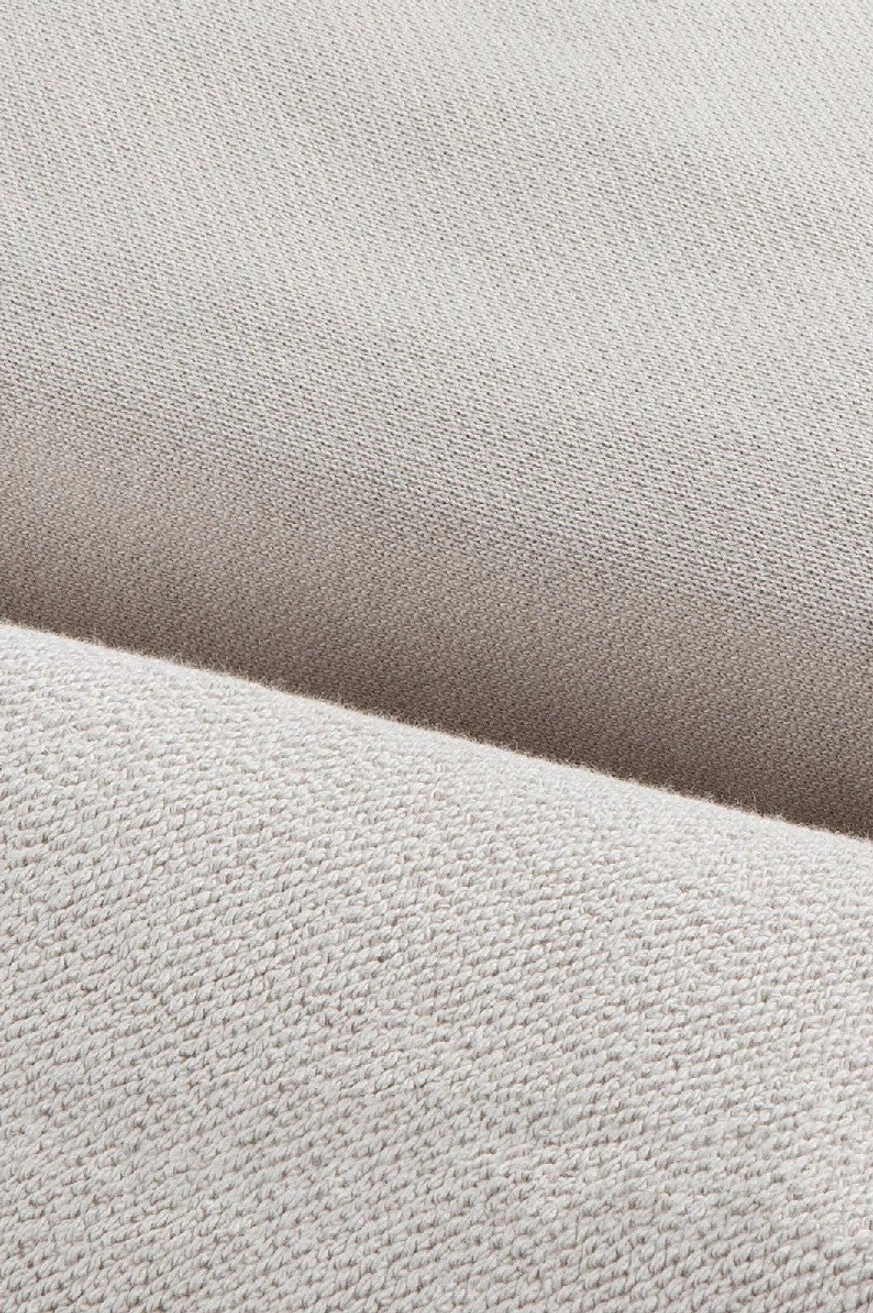 Close-up detail of heavyweight cotton hoodie fabric showing smooth jersey exterior and soft brushed fleece inner texture