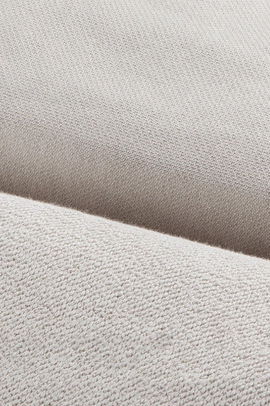Close-up of heavyweight cotton sweatpants fabric showing soft dense textured knit surface