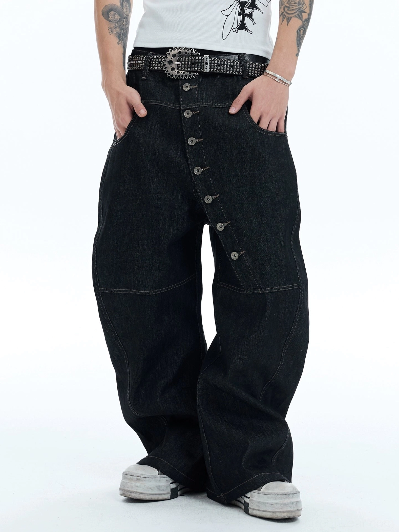 Close-up of high-waisted asymmetric button fly wide-leg jeans with diagonal placket and belt loops