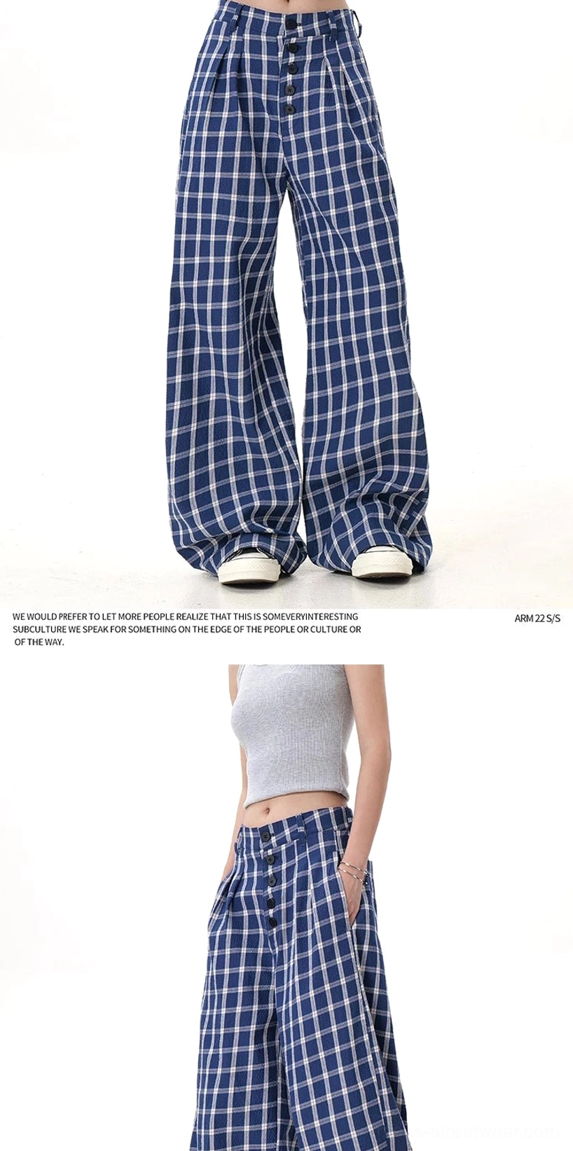Detailed product view of high-waisted plaid wide-leg pants with button-front tailoring and oversized check streetwear styling