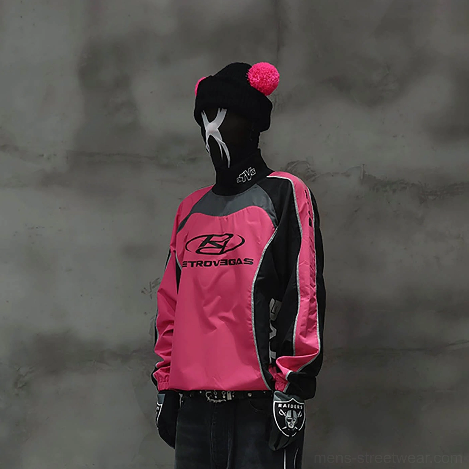 Hot pink and black racing jersey styled with belted dark jeans for a bold streetwear outfit