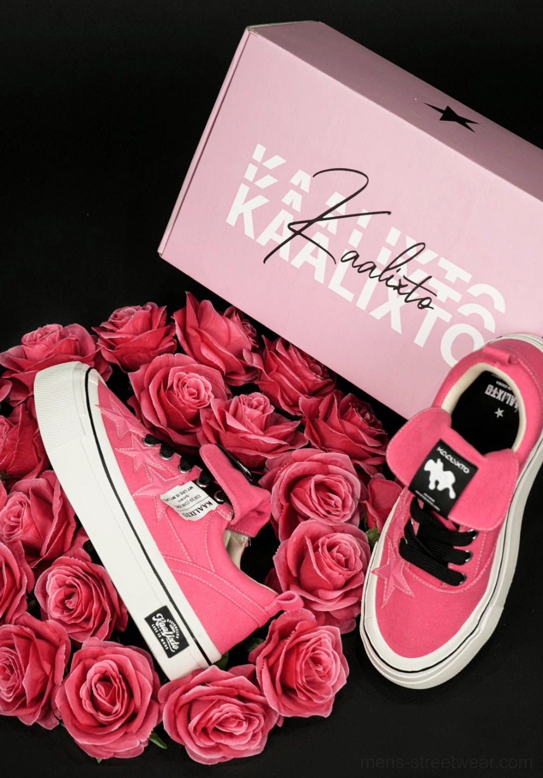 Pair of hot pink canvas platform sneakers displayed from above with white rubber soles and pink roses in a styled flat lay
