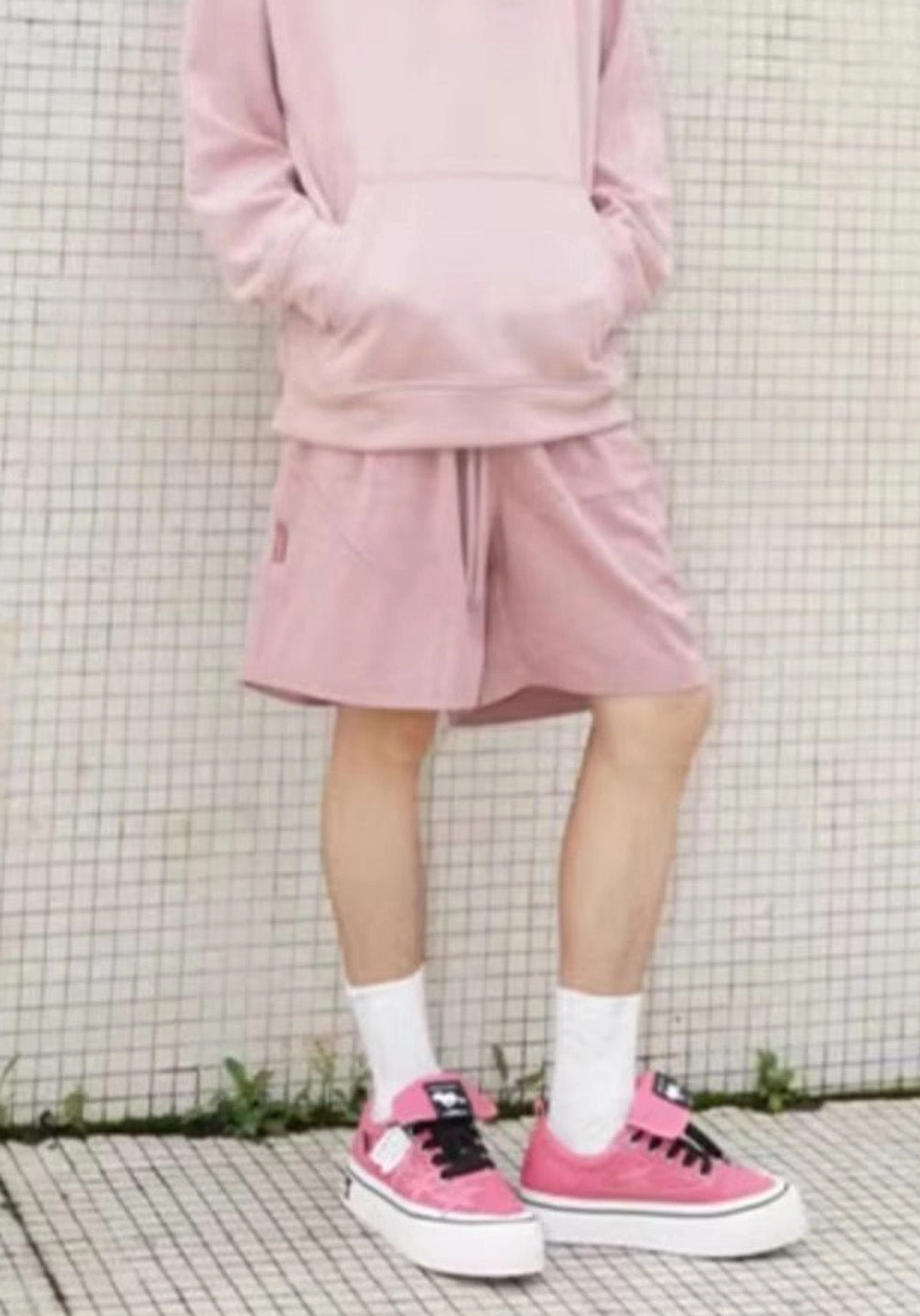 Hot pink star panel canvas platform sneakers worn with a matching pink hoodie and shorts in a casual unisex streetwear look