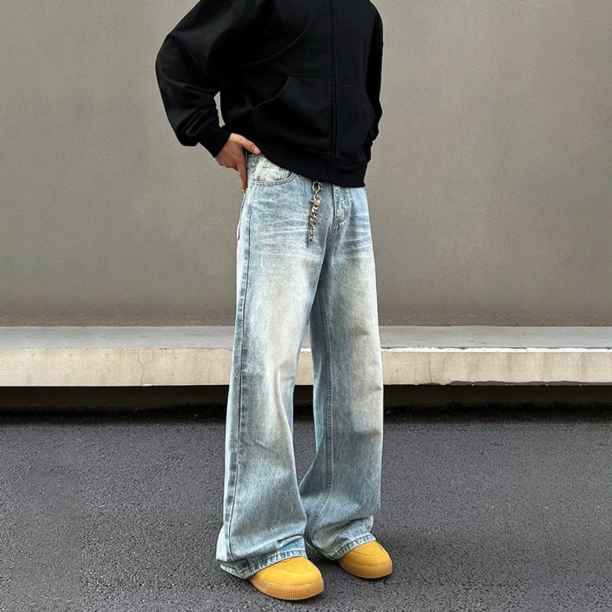 Front three-quarter view of ice fade light blue wide straight leg jeans with button waist, five-pocket design and relaxed fit