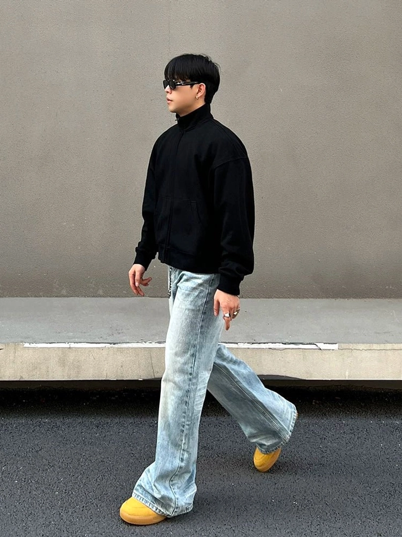 Side walking view of light blue ice fade wide leg straight jeans showing the relaxed drape and faded denim texture