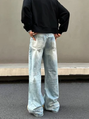 Rear view of ice fade vintage light blue wide straight leg jeans with loose streetwear fit and classic back patch pockets