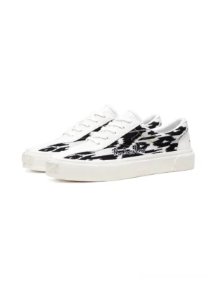 Front three-quarter view of matched unisex ikat pattern low-top skate sneakers with white toe caps laces and rubber soles