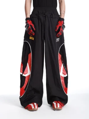 Black inferno vector color-block wide-leg track pants front view with red graphic side panels