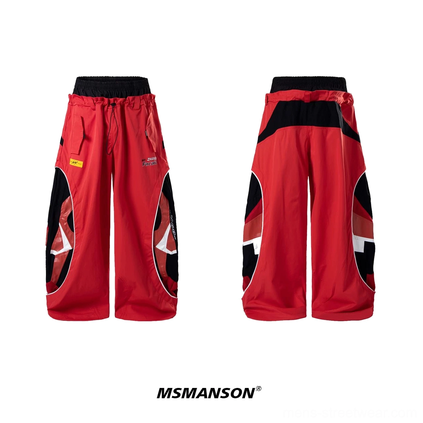 Red inferno vector wide-leg track pants flat lay showing elastic drawstring waist and contrast side graphics