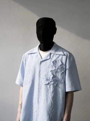 Light blue pinstripe camp collar shirt with 3D iris floral appliques, chest pocket, short sleeves, and front button placket