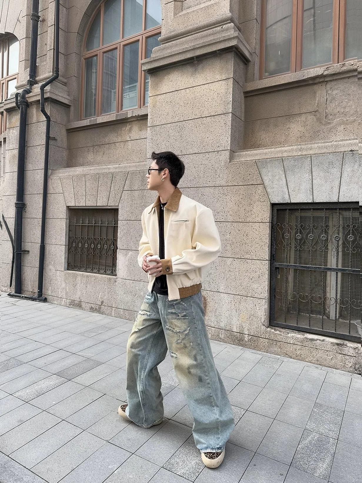 Side back view of ivory contrast corduroy collar jacket showing relaxed streetwear fit with wide-leg denim