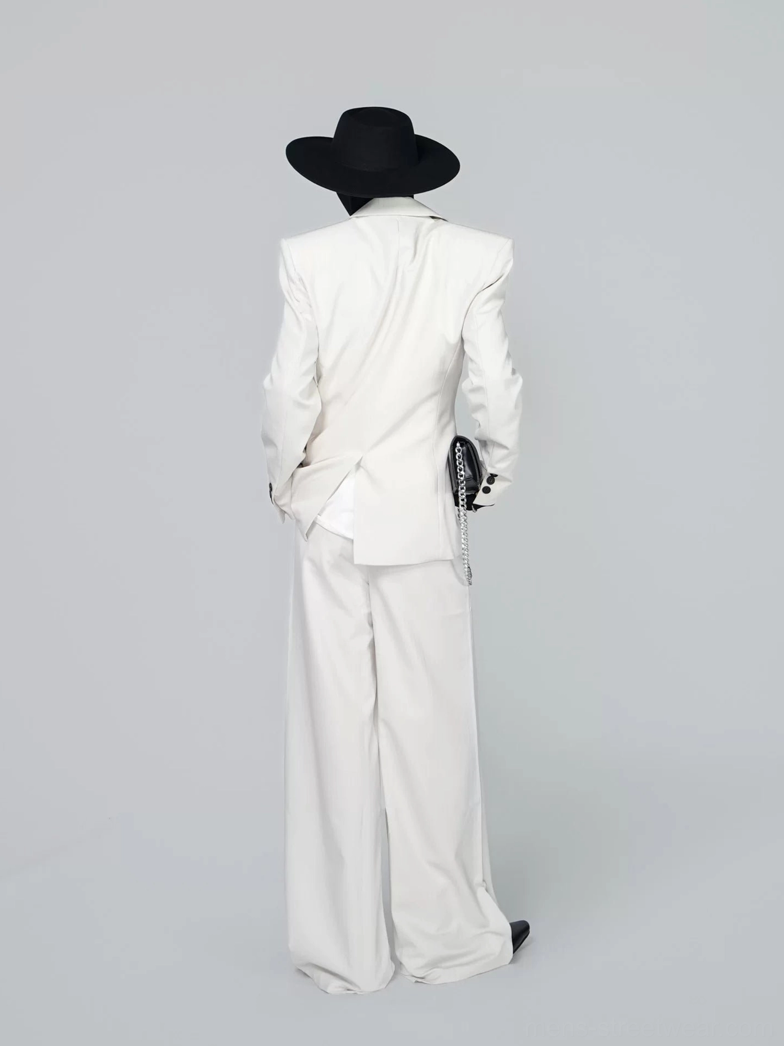 Back view of ivory double-breasted tailored suit set showing longline blazer vent and wide-leg trousers