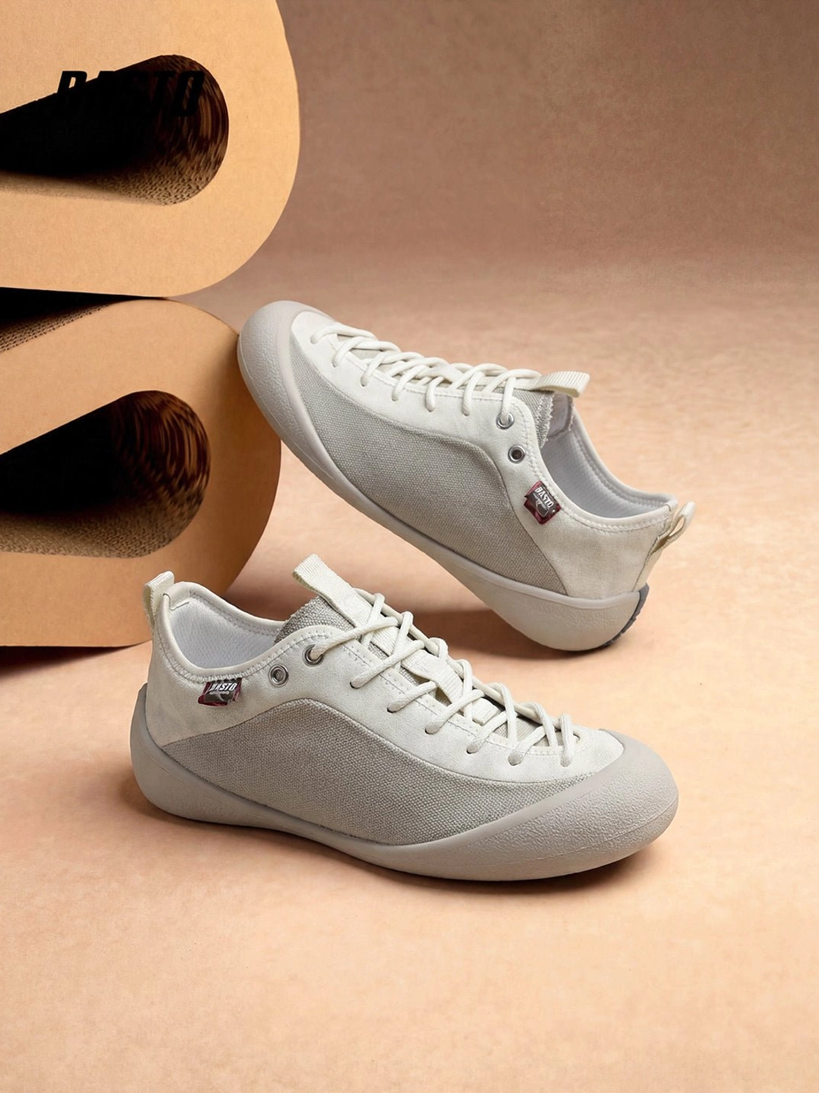 Overhead flat lay of matching ivory low-top mesh-panel canvas sneakers with tonal panels and woven laces