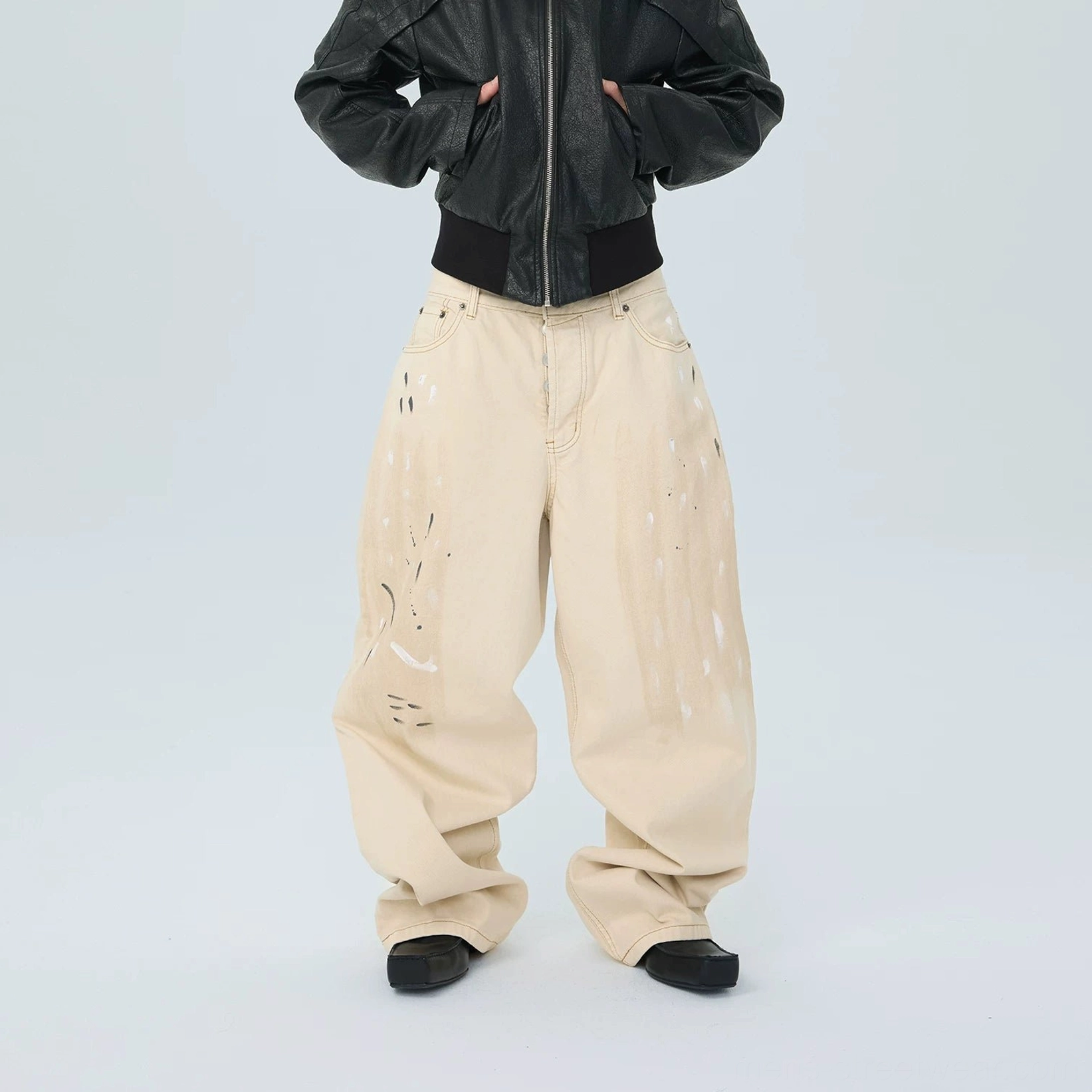 Full outfit view of distressed white ivory paintstroke balloon stack jeans with relaxed oversized wide legs