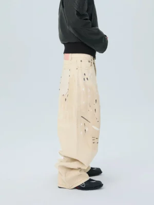 Ivory paintstroke balloon stack jeans rear side view with oversized wide leg fit and abstract splatter print