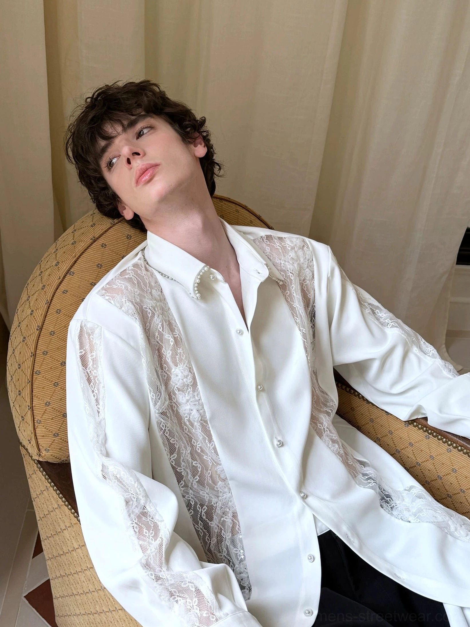 Close view of men's ivory oversized longline shirt with sheer floral lace panels and pearl-style collar detail