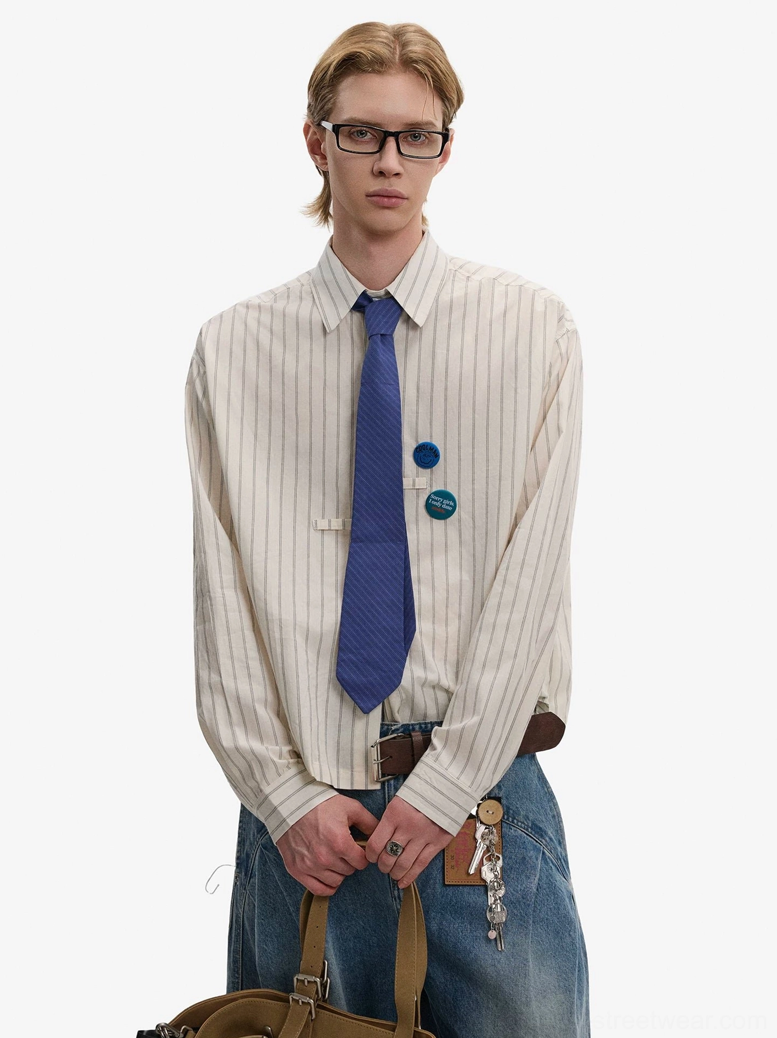Ivory striped Korean officecore shirt with blue tie and decorative blue brooches paired with wide-leg denim pants