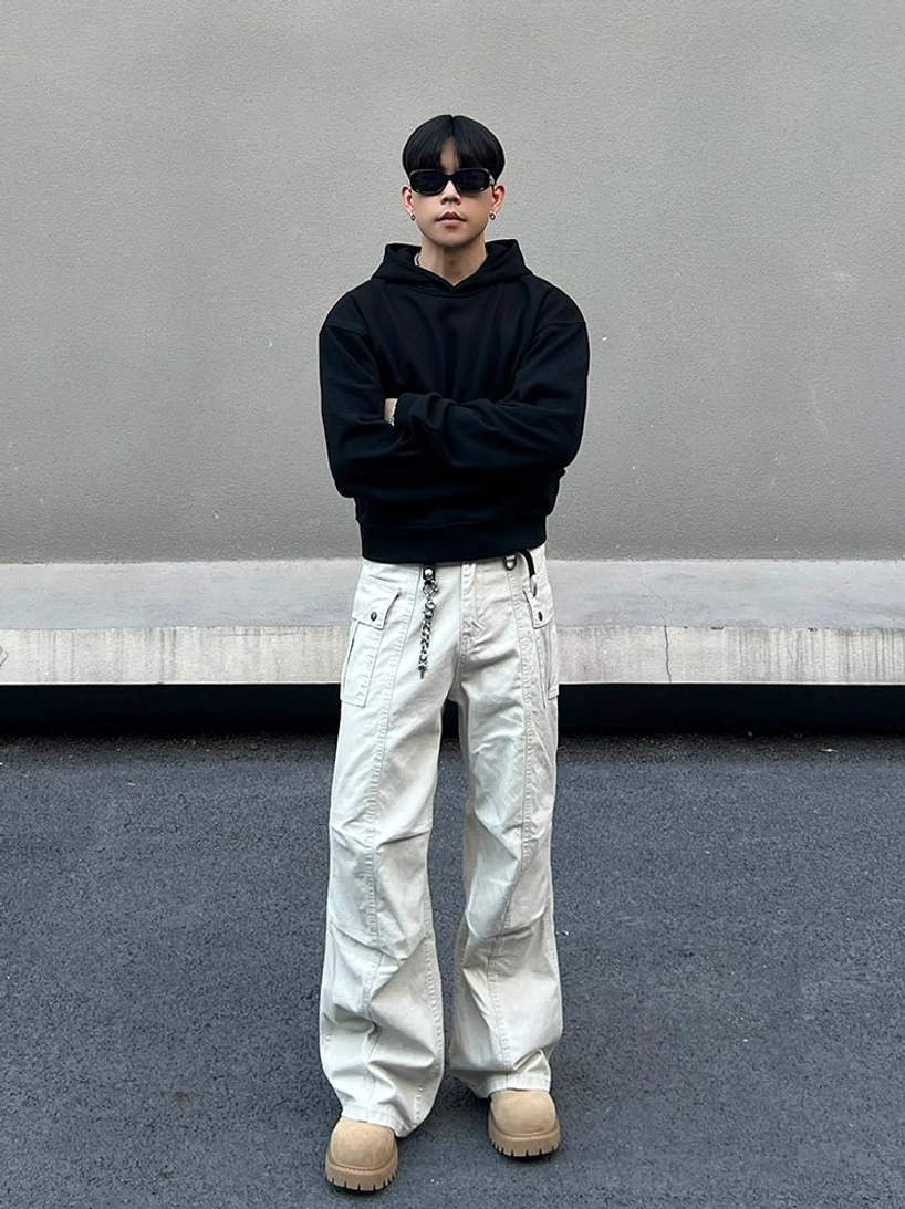 Full outfit view of ivory wide leg utility cargo pants with metal chain detail in Korean streetwear styling