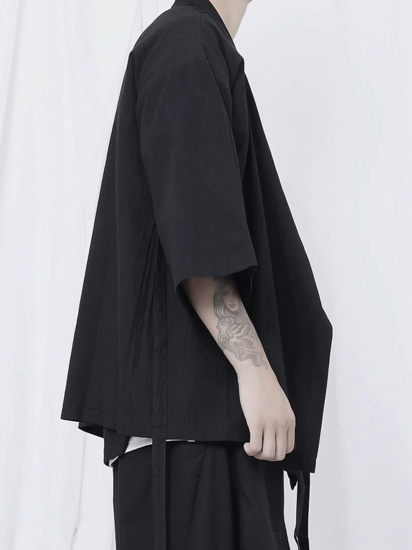 Japanese-inspired black wrap shirt with loose kimono sleeves and avant-garde oversized silhouette
