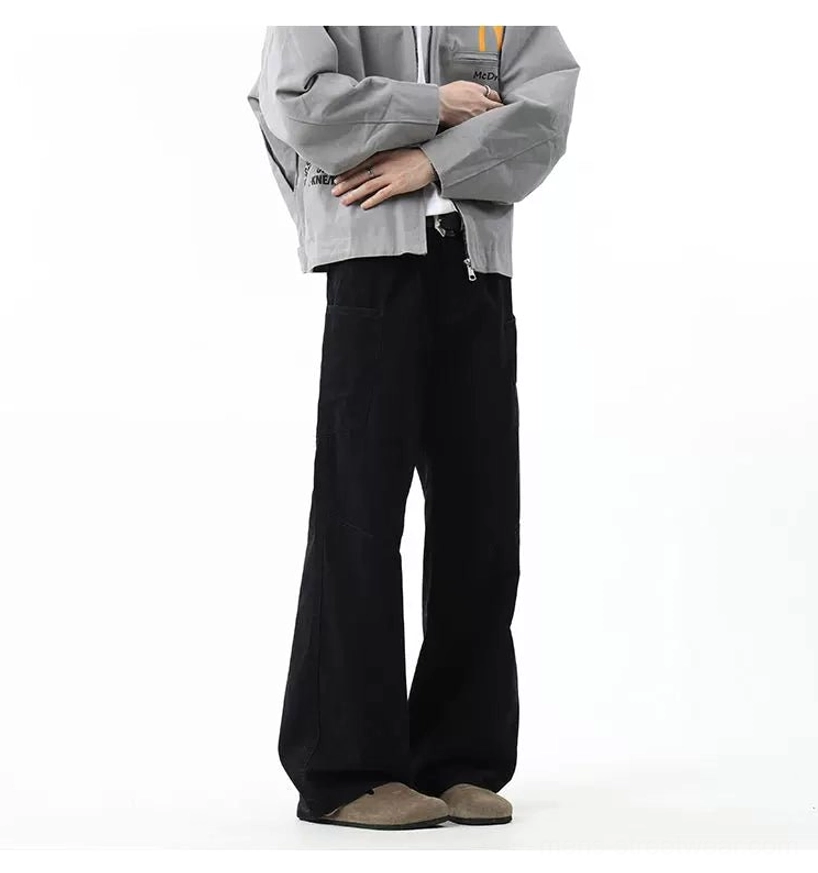 Jet black baggy wide-leg cargo pants with belt loops and structured leg seams shown in a front studio streetwear look