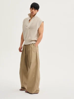 Khaki Acubi wide-leg drawstring cotton pants shown in a left three-quarter full-body studio view with relaxed draping