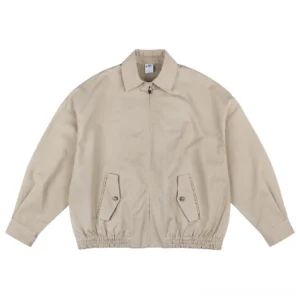 Khaki beige oversized work jacket in textured cotton twill with front zipper flap pockets and elasticated hem
